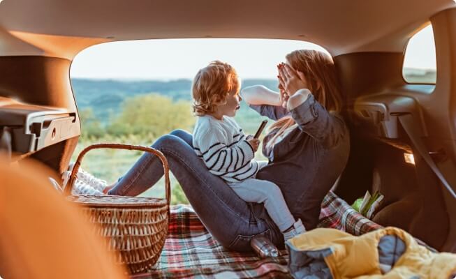 Family having picnic in back of car