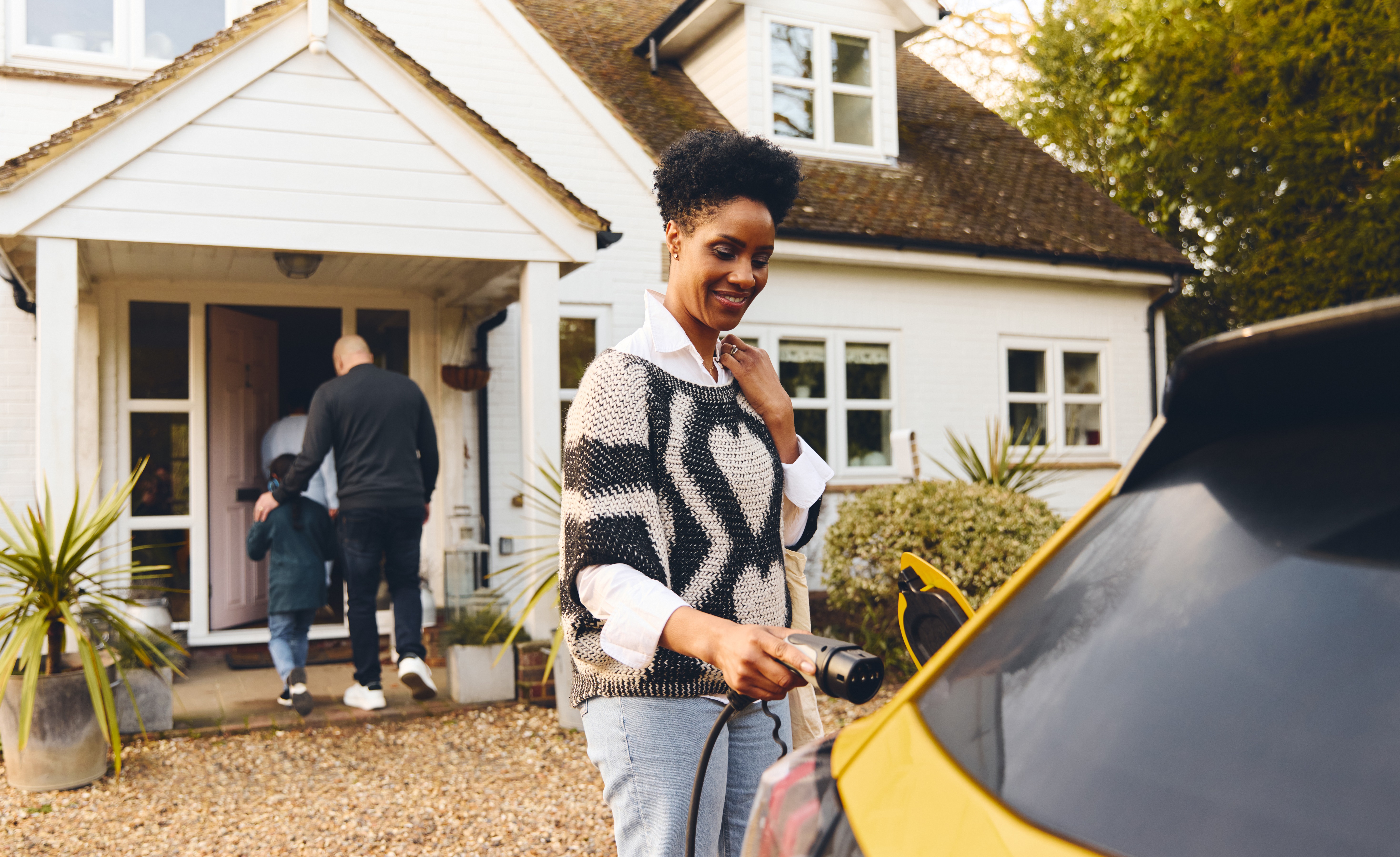 Family charging car at home