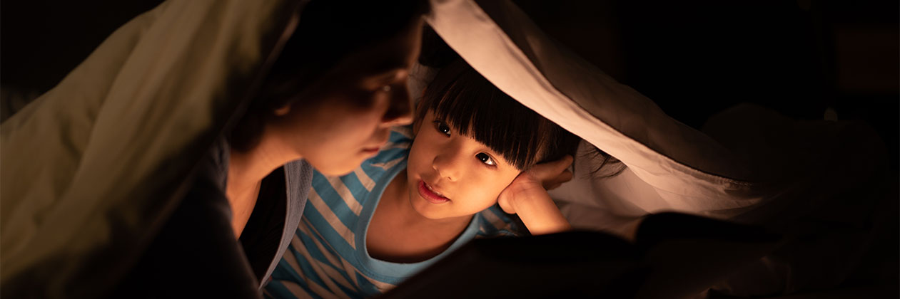 kid under blanket cover during a power outage